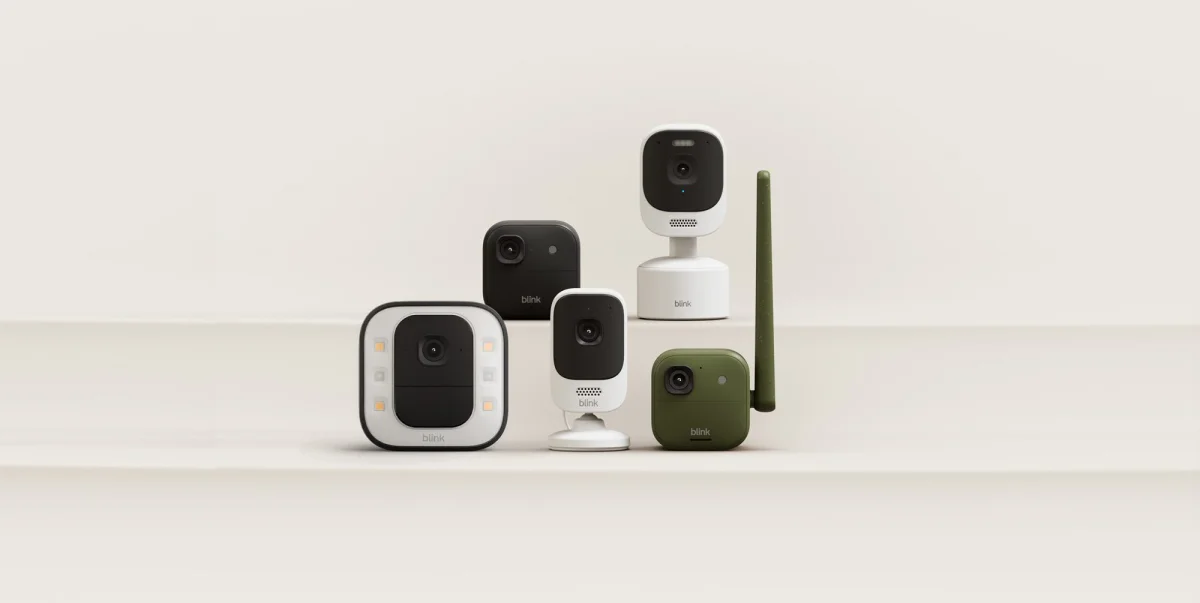 A group of cameras on a white surface