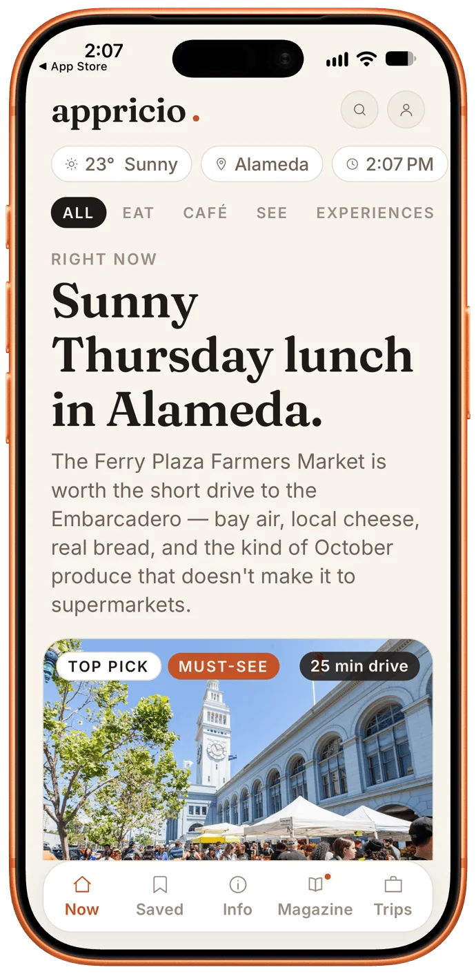 iPhone screenshot of the Appricio app showing the headline "Sunny Thursday lunch in Alameda." Text recommends the Ferry Plaza Farmers Market, a 25 min drive. A Top Pick, Must-See photo shows the Ferry Building clock tower and market tents.