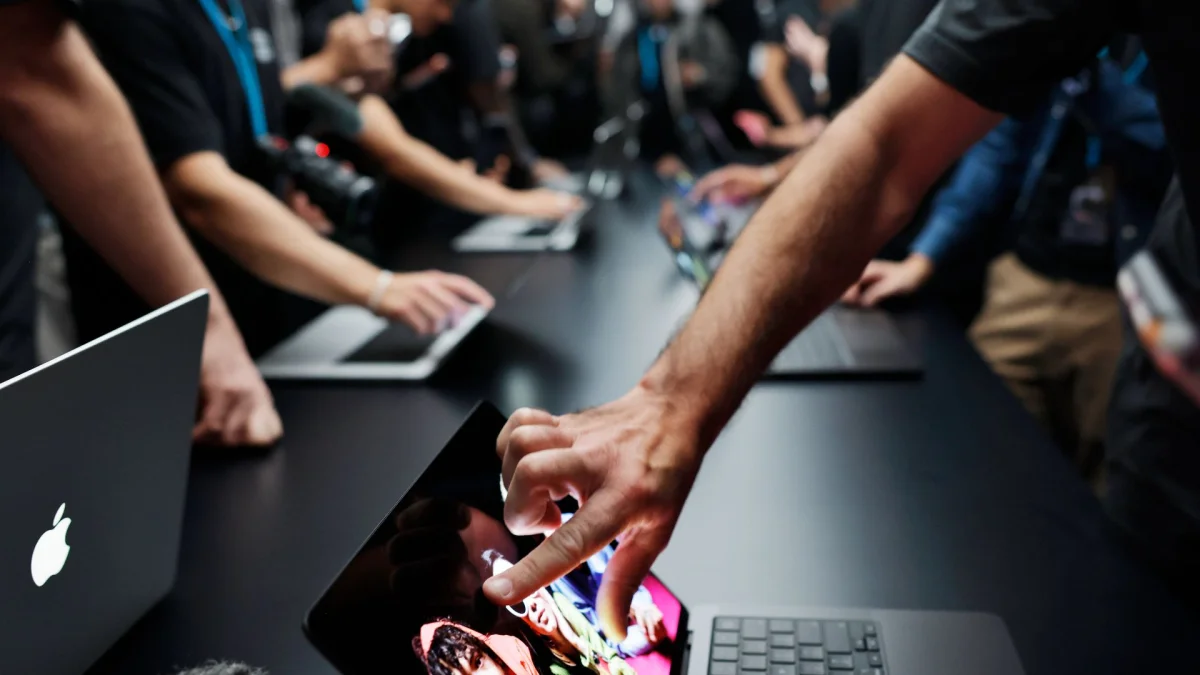 Attendees view the new touchscreen MacBook Pro at the Apple “Pro and Tell” event on October 28, 2026 in Los Angeles, California